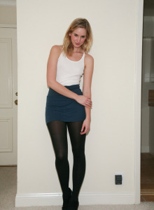 Sexy playful baby is at home wearing a skirt with black pantyhose