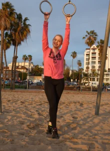 Amazing sexy blonde is on the beach wearing black spandex