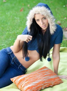Exciting puffy nipples brunette in tight denim jeans poses outside