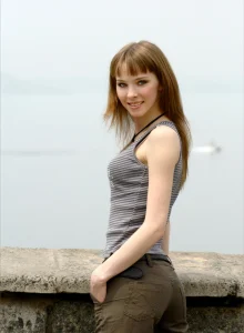 Pretty sexy girl walking in the city dressed in tight top and jeans