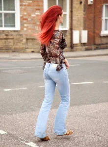 Redhead chick has fun on the street on tight denim jeans