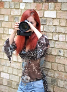 Redhead photographer in tight blue jeans