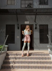 Sexy baby is at the street dressed in tight top and mini skirt flashing green panties