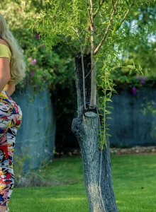 Sexy busty blonde wearing spandex in the summer garden