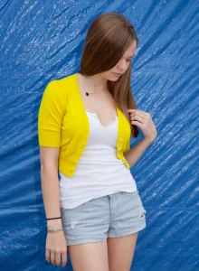Sexy teen is outside wearing shorts