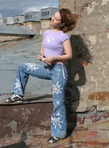 Smoking on the roof in denim jeans hidding puffy nipples under tight t-shirt