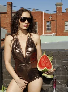 Tight bronze shiny spandex girl with cameltoe and puffy nipples